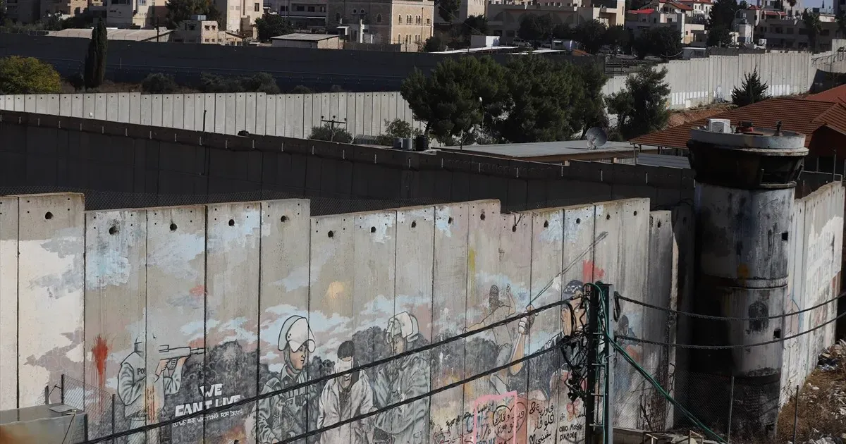 ‘I lost both legs’: Palestinians scale separation wall for chance to work